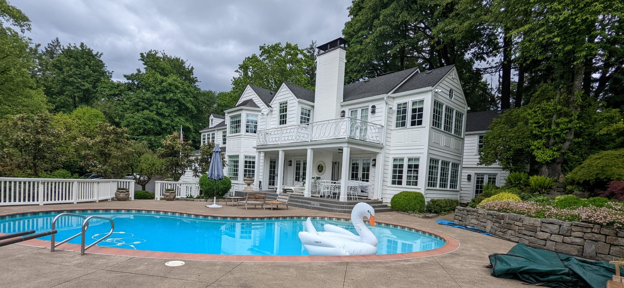 White painted home with poolside exterior and detailed trim
